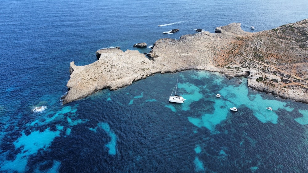 a group of boats floating on top of a body of water