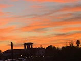 A vibrant sunset behind the club’s building adorned with the raízes unidas logo and Portuguese flags.