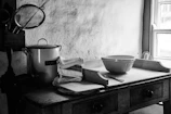 A cozy kitchen corner featuring a set of ceramic mixing bowls stacked beside a vintage stand mixer.