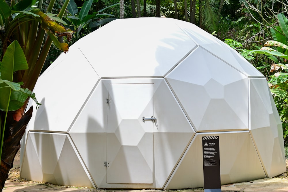 a large white object sitting in the middle of a forest