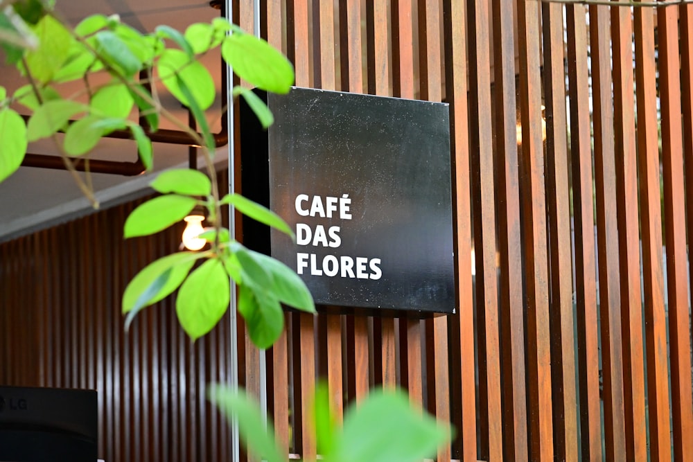 a sign on a wall that says cafe des flores