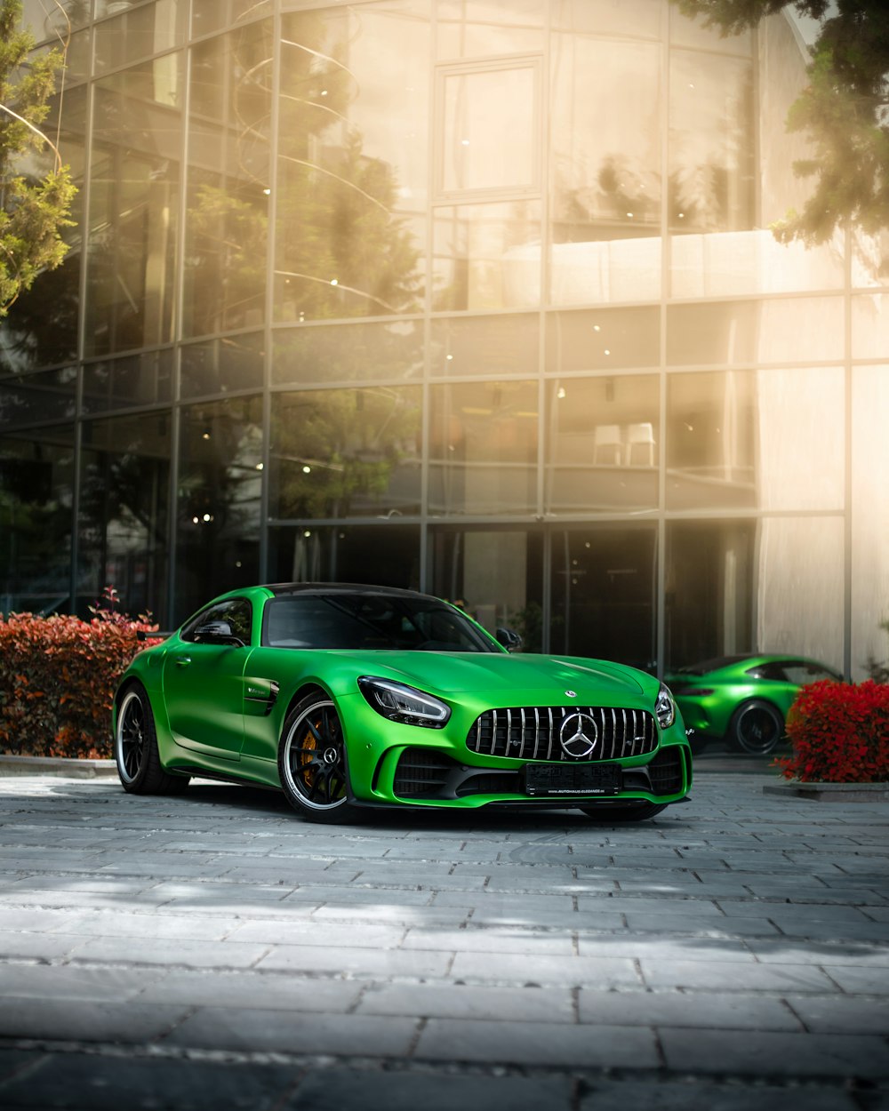 a green sports car parked in front of a building