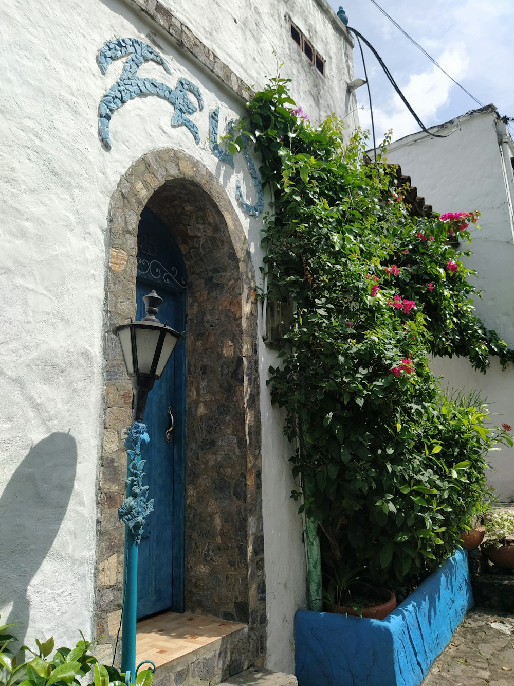 a white building with a blue door and window