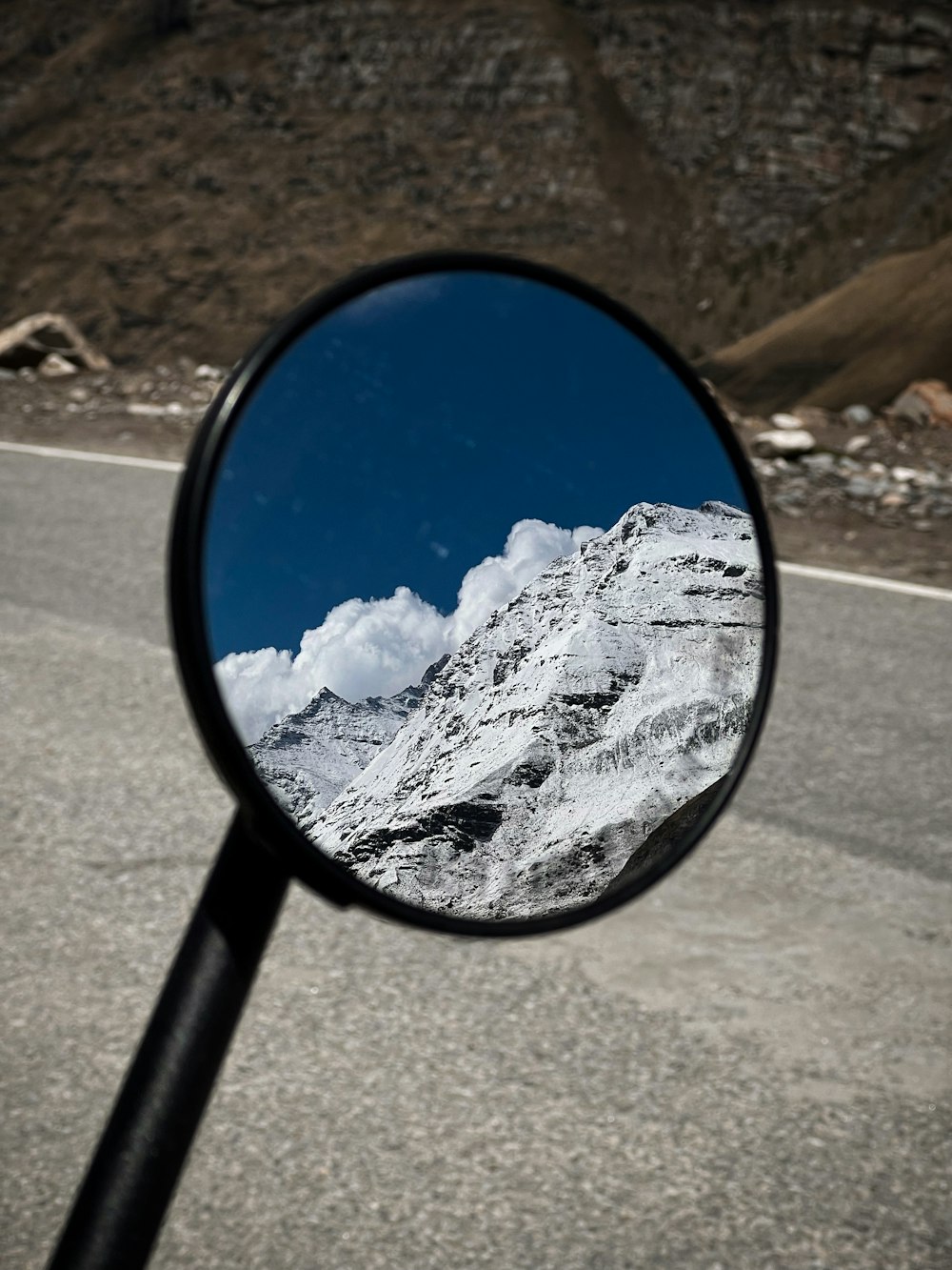 a rear view mirror on the side of a road
