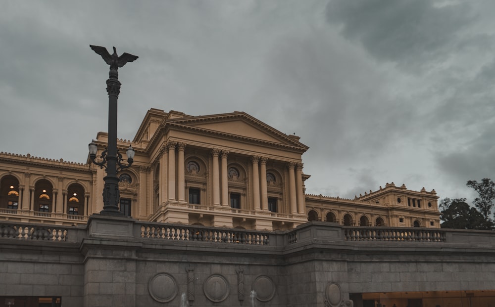 a large building with a tall light pole in front of it