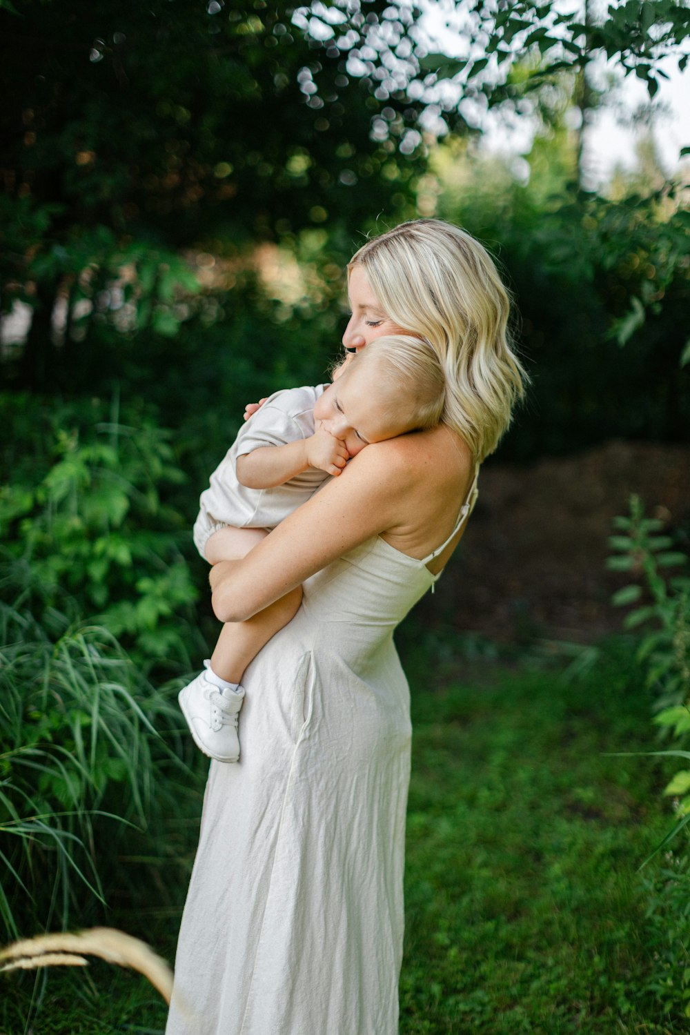 a woman holding a baby in her arms