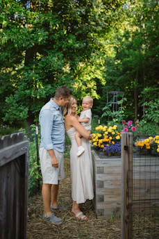 A family working together planting seedlings in their vibrant garden.