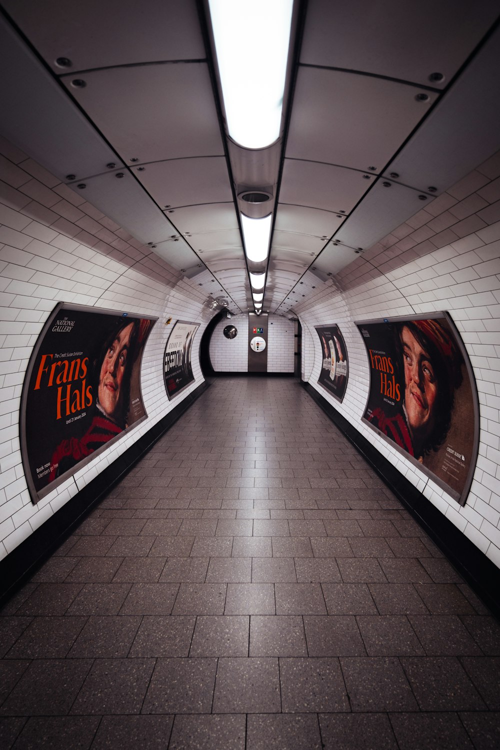 a subway station with posters on the walls