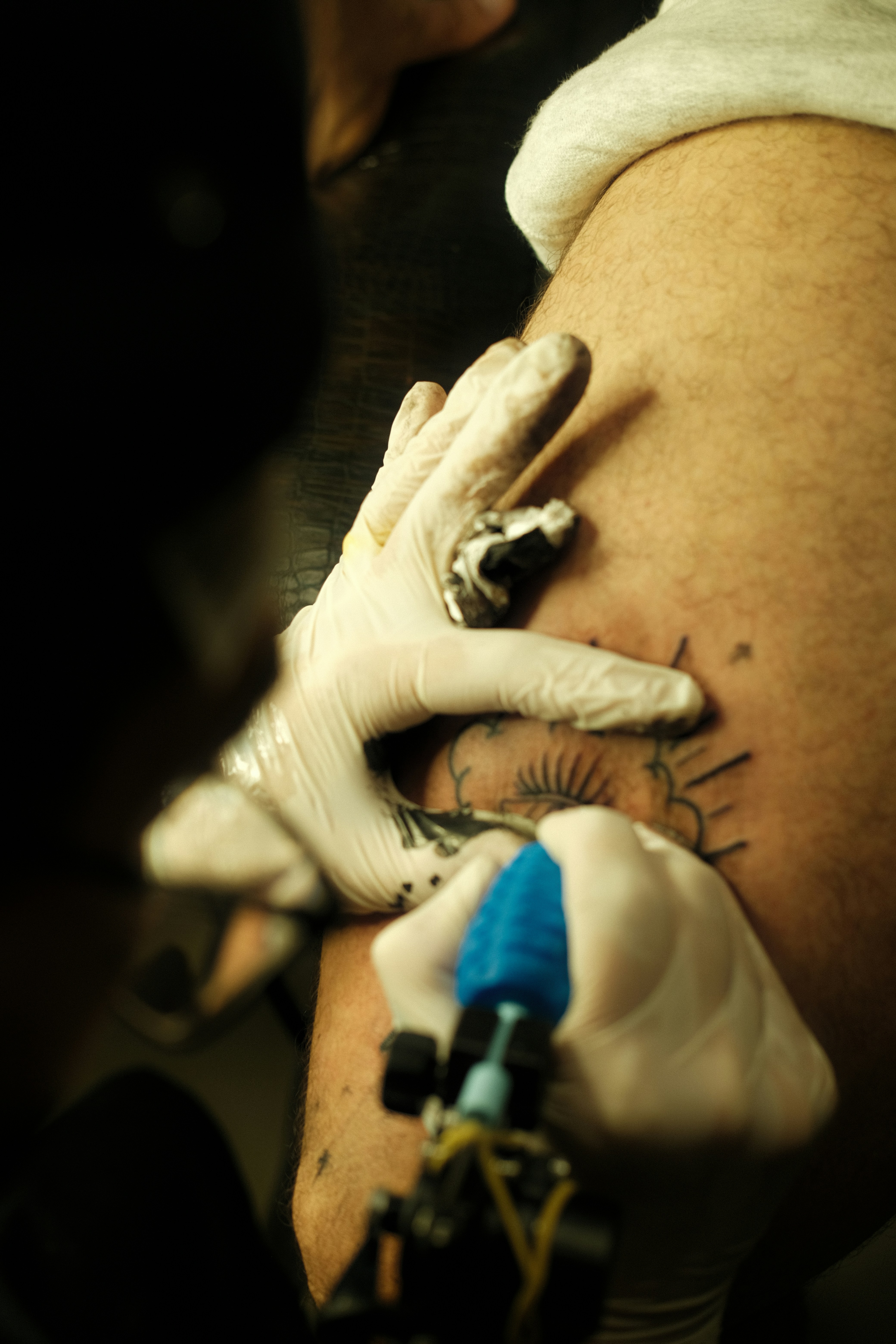 a man getting a tattoo on his thigh