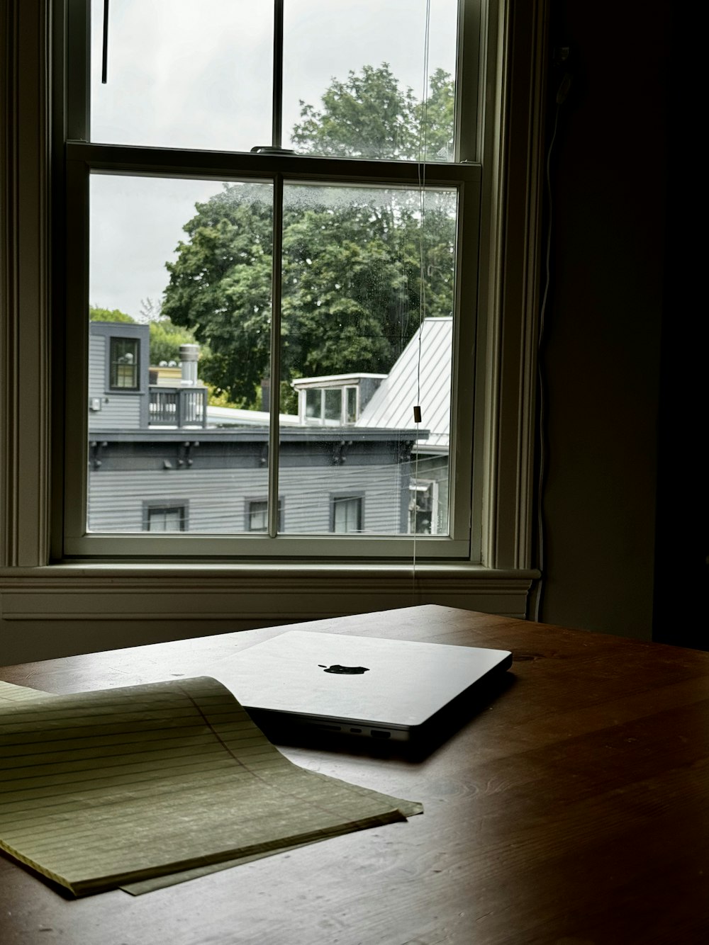 a laptop computer sitting on top of a wooden table