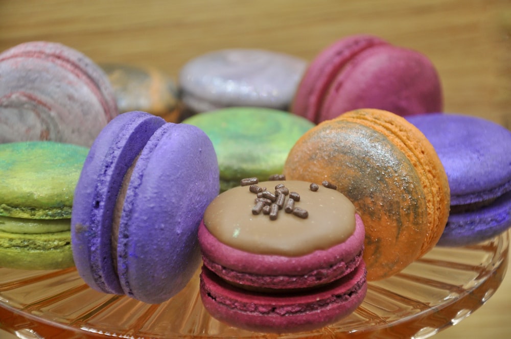 a glass plate topped with different colored macaroons