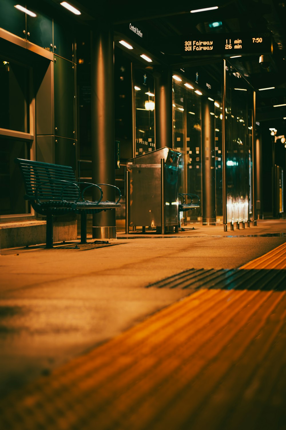 a bench sitting on a sidewalk next to a building