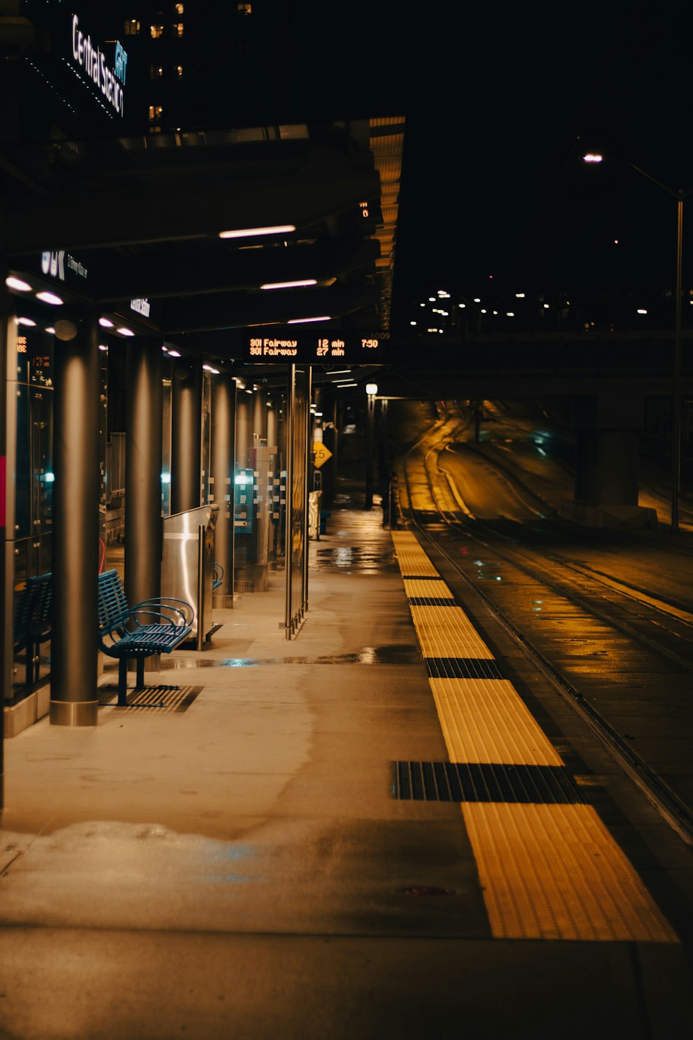 a bench sitting on the side of a train station