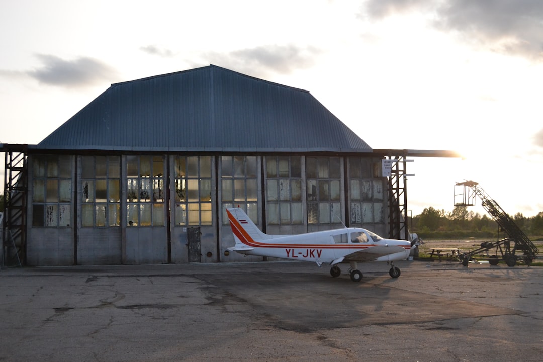a small airplane parked in front of a building,
