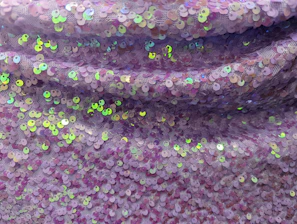 Close-up of a shimmering rhinestone transfer on a black hoodie, highlighting intricate detail and sparkle.
