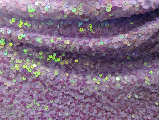 Close-up of a shimmering rhinestone transfer on a black hoodie, highlighting intricate detail and sparkle.