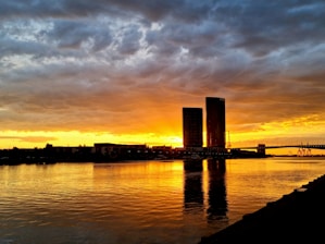 Sunset over the Danube River with the Parliament building glowing in warm light.