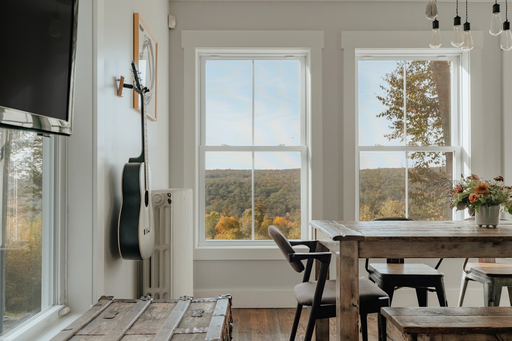 a dining room table with chairs and a television