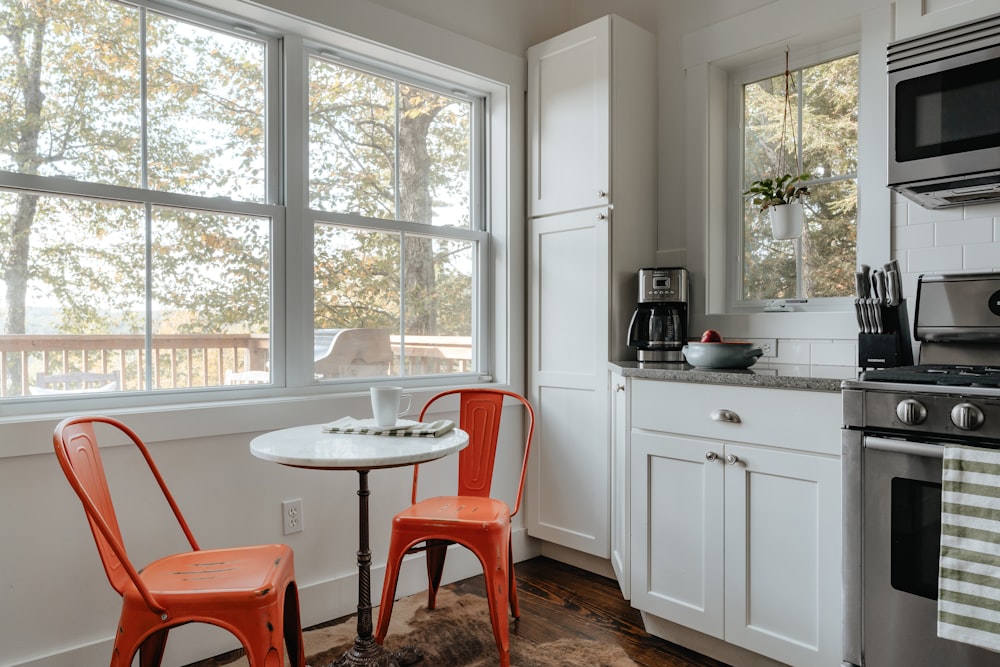 a kitchen with a table and two chairs