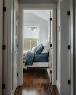 a bed sitting in a bedroom next to a doorway