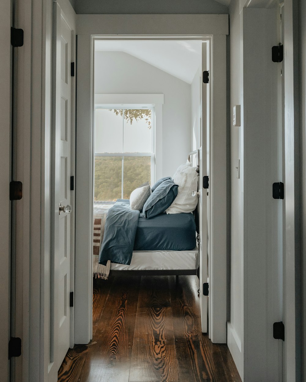 a bed sitting in a bedroom next to a doorway