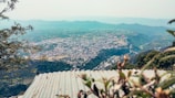 A panoramic view of the Vale Norte landscape with green hills and small businesses.