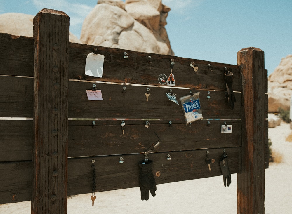 a close up of a wooden fence with a rock in the background