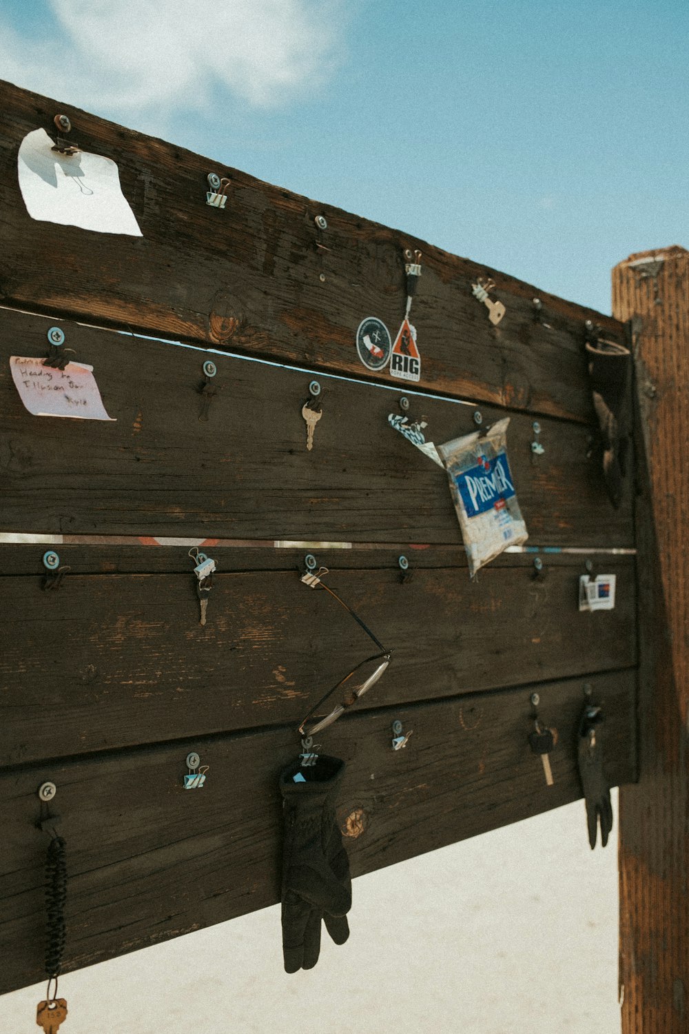 a close up of a wooden sign with a bunch of magnets on it