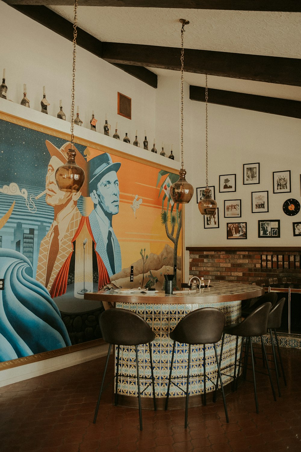 a dining room with a painting on the wall