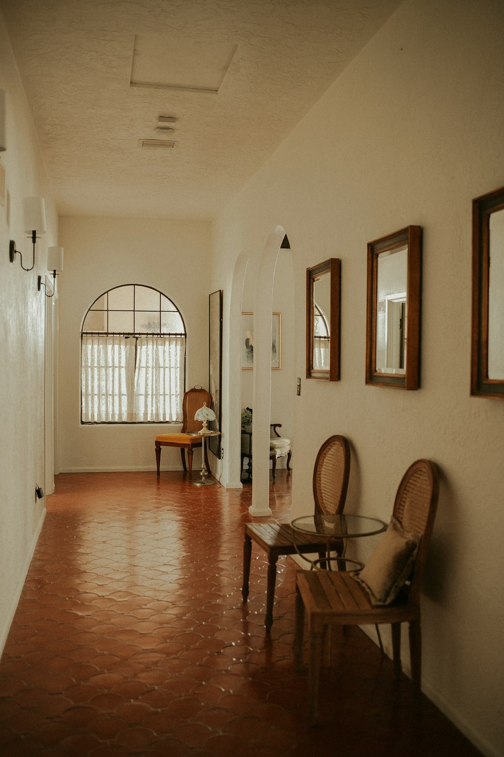 a hallway with a chair and a table in it