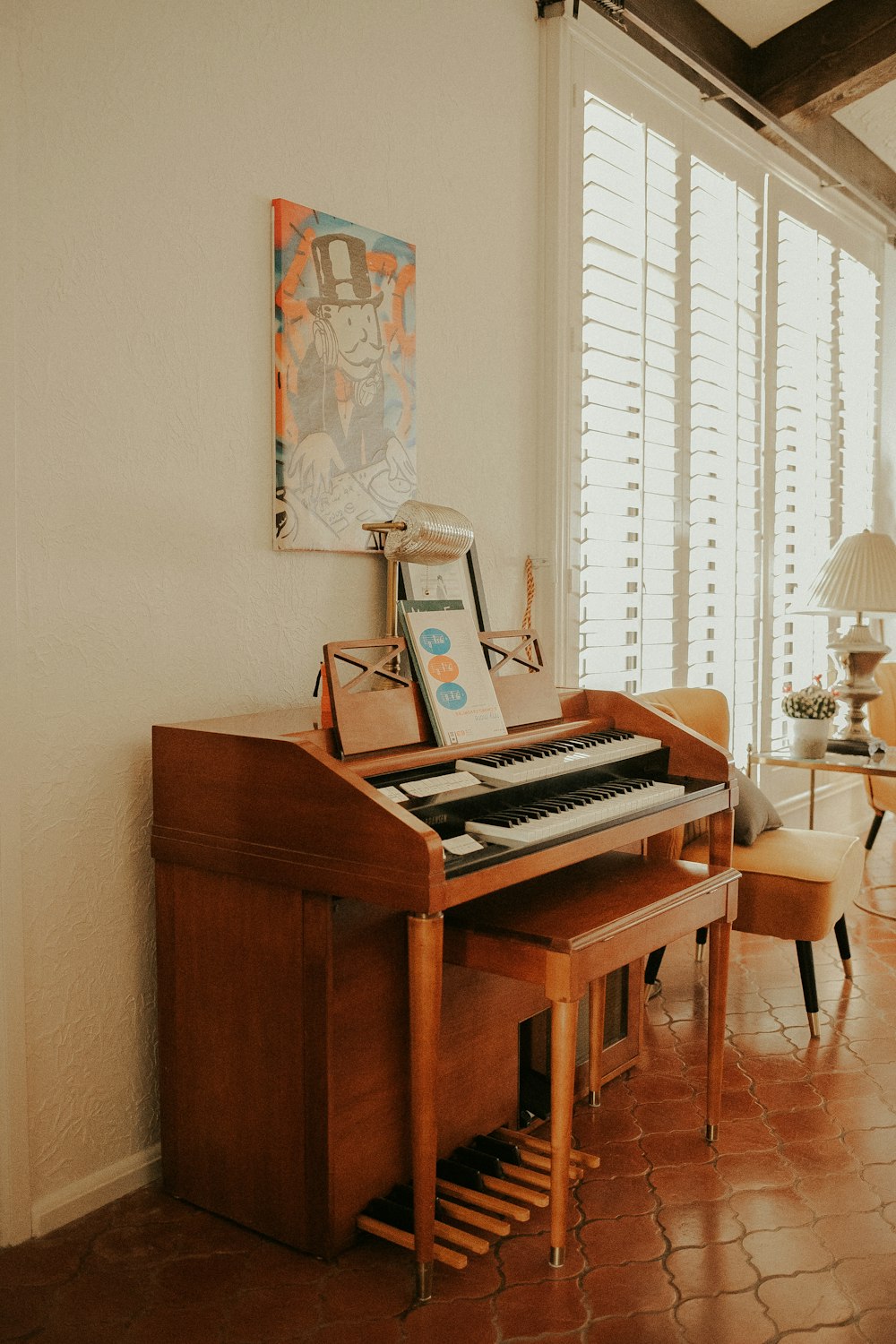 a living room with a piano and a chair