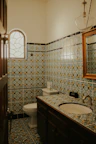Bathroom featuring minimalist design with vibrant Mexican tile accents