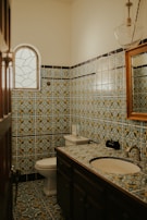 A vibrant bathroom with colorful mosaic tiles.