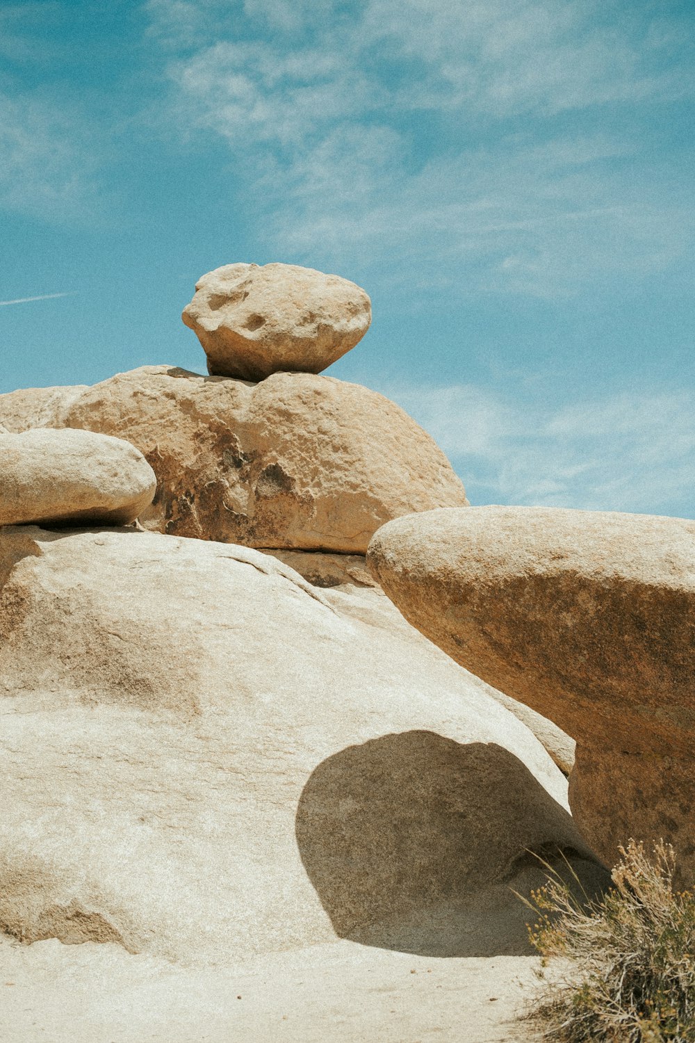 a pile of rocks sitting on top of a sandy beach