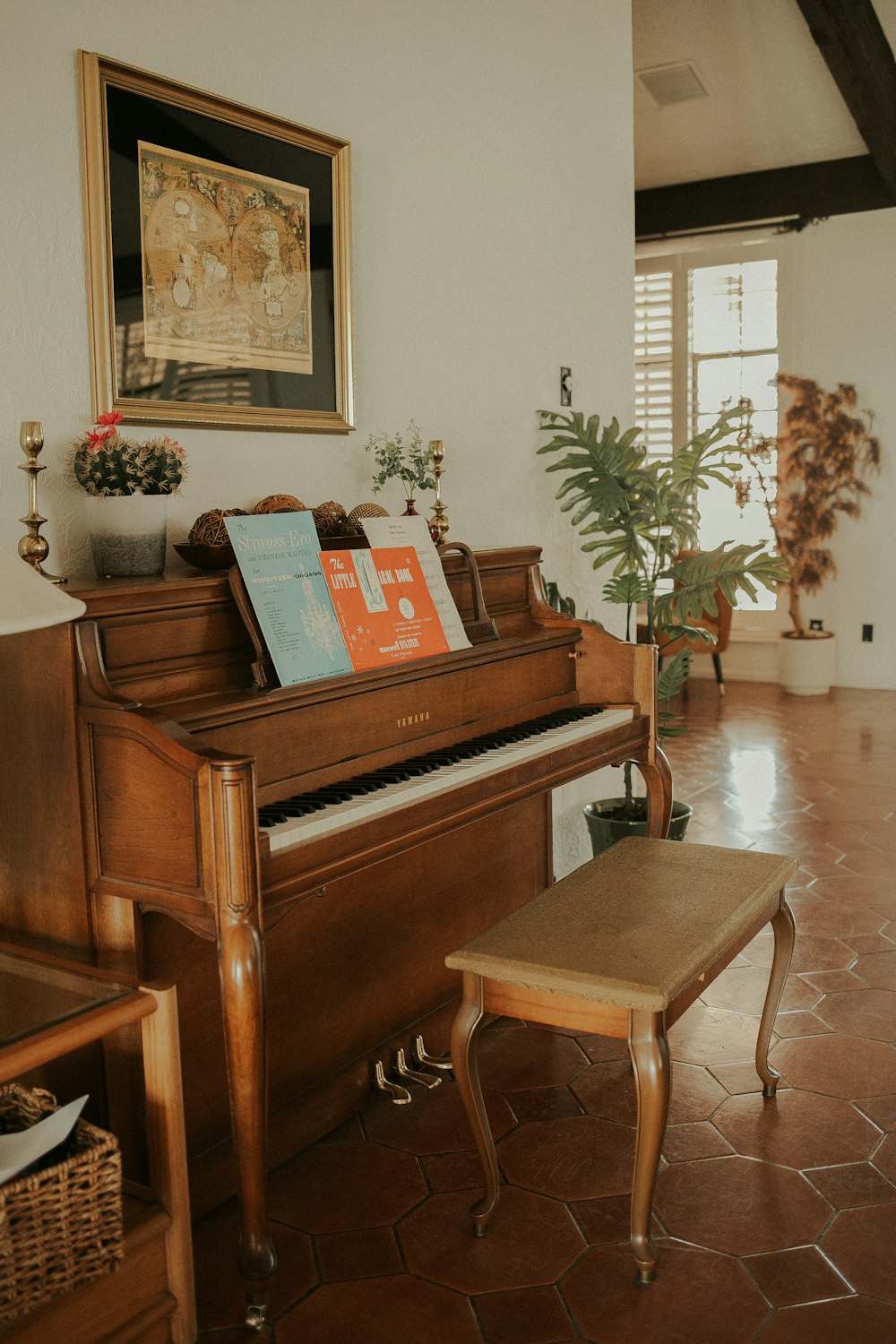 a living room with a piano and a bench