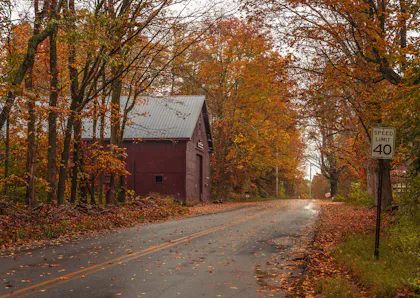Country road past a barn in autumn