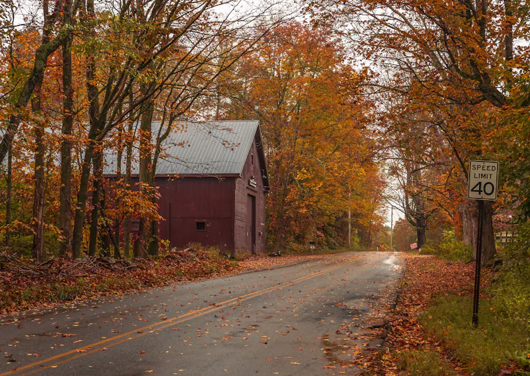 Country road past a barn in autumn