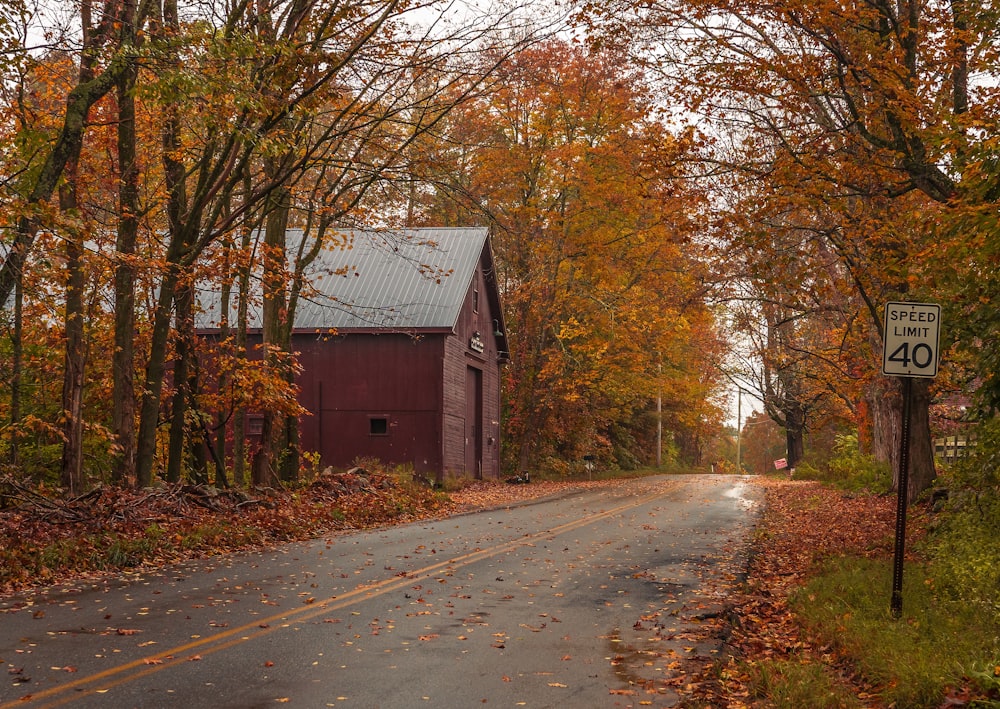 a country road with a barn in the background