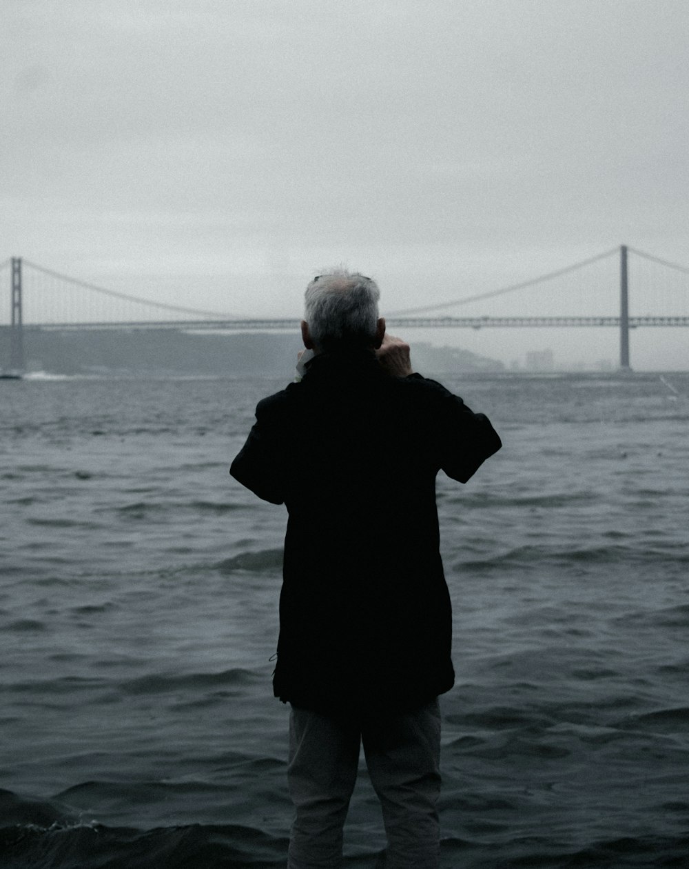 a person standing in front of a body of water