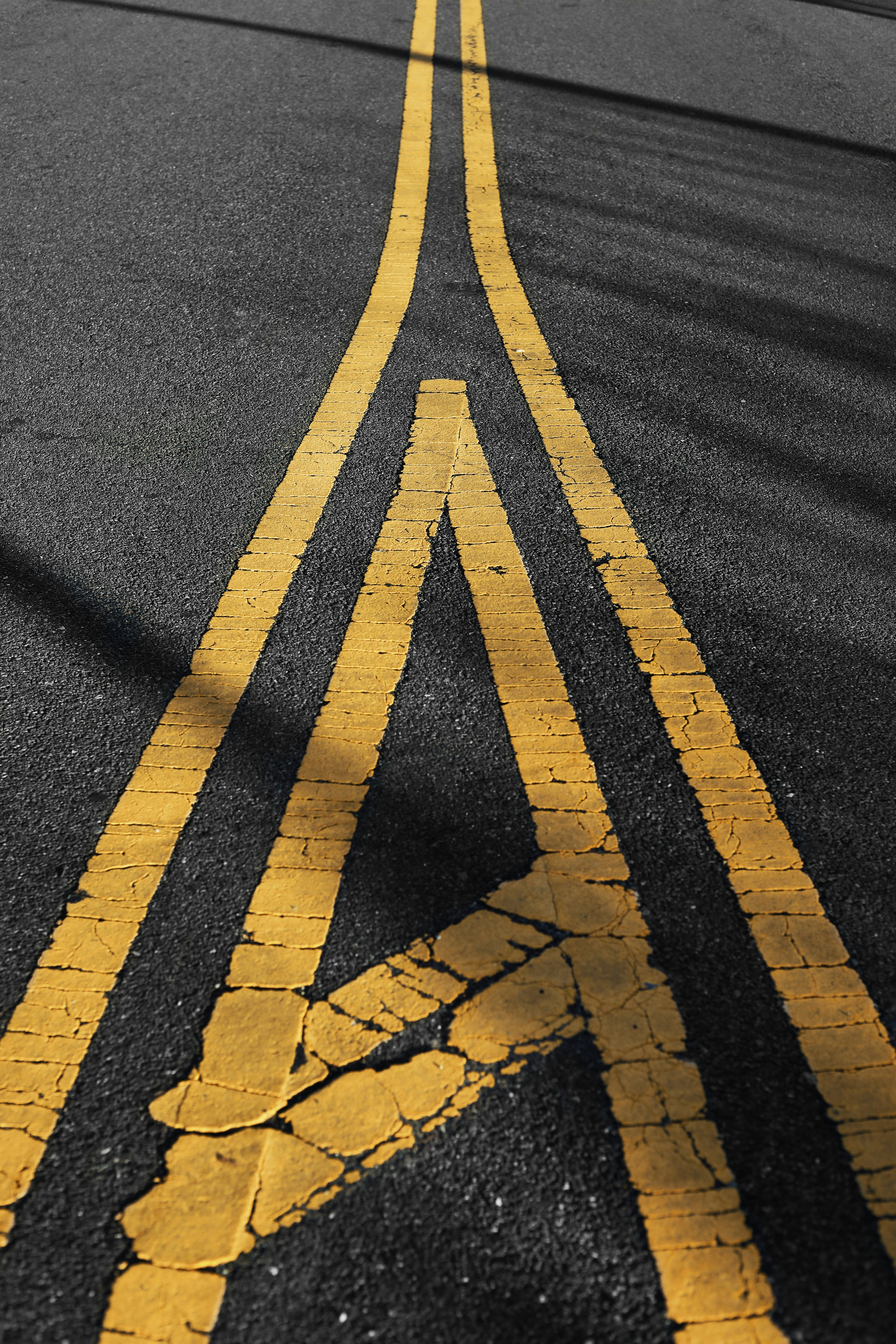 A yellow line painted on the road in the middle of the road photo