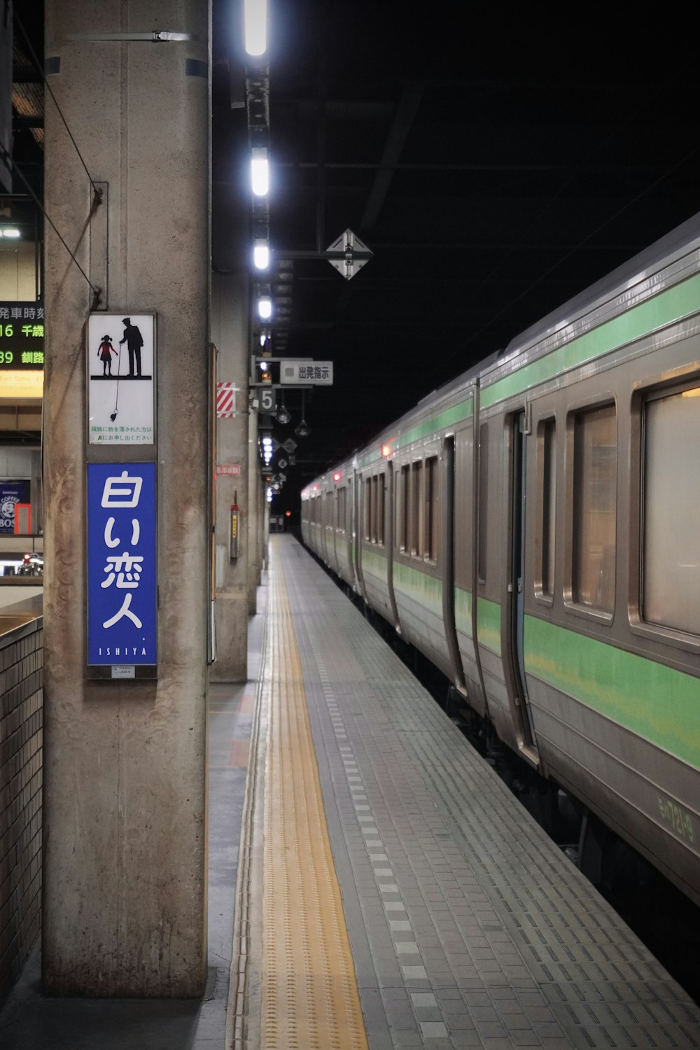 a train pulling into a train station next to a platform