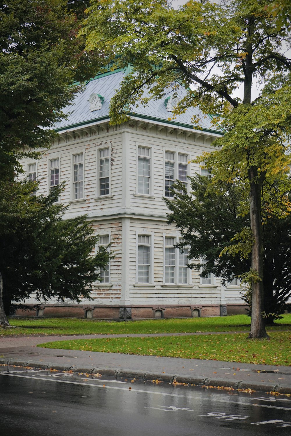 a large white house with a blue roof