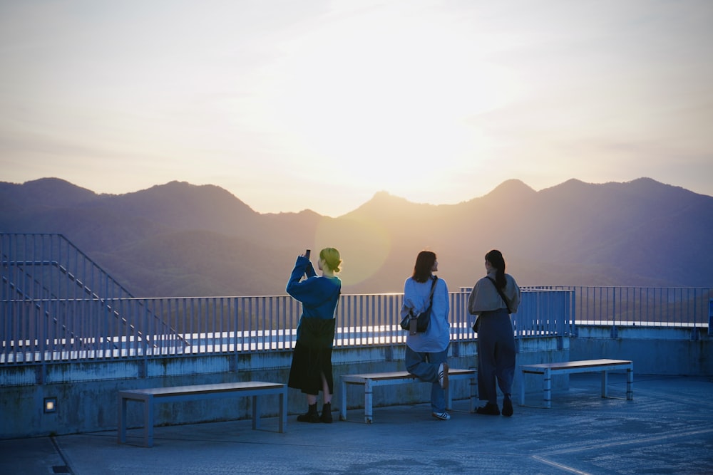 a group of people standing on top of a roof