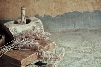 A serene scene of a mortar and pestle surrounded by fresh medicinal plants and leaves.