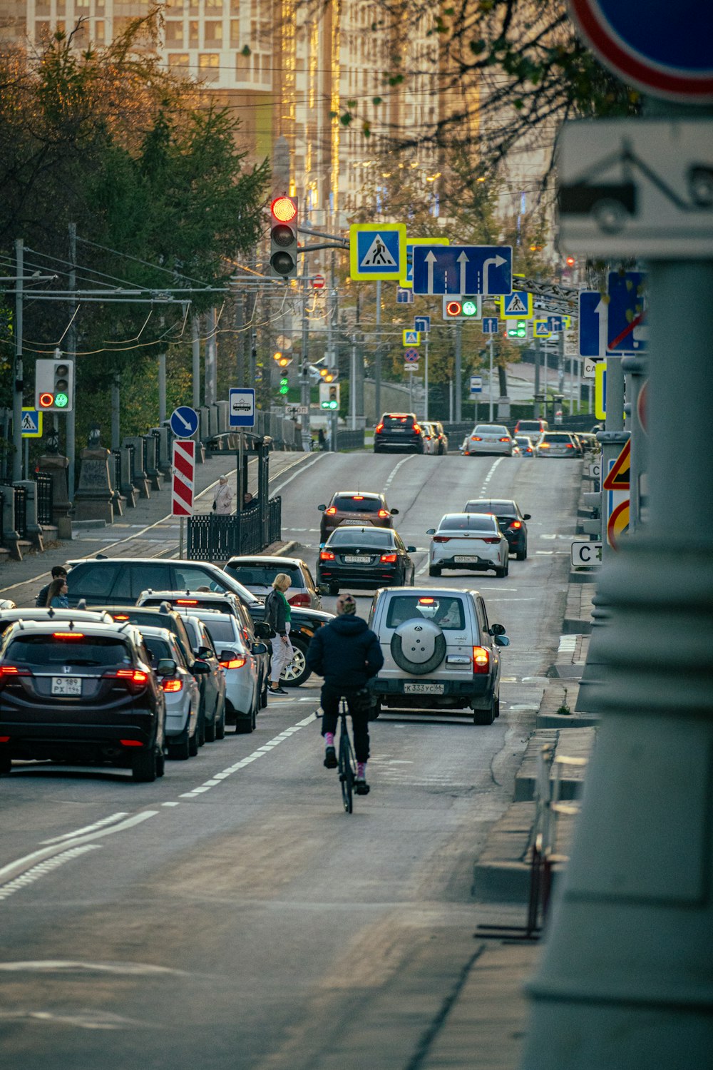 a man riding a bike down a street filled with traffic