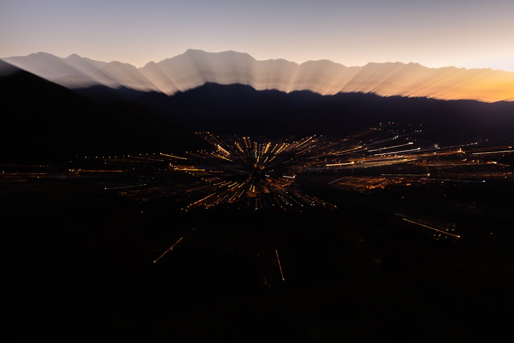 an aerial view of a city with mountains in the background