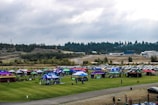 An aerial view of an outdoor festival with colorful tents.