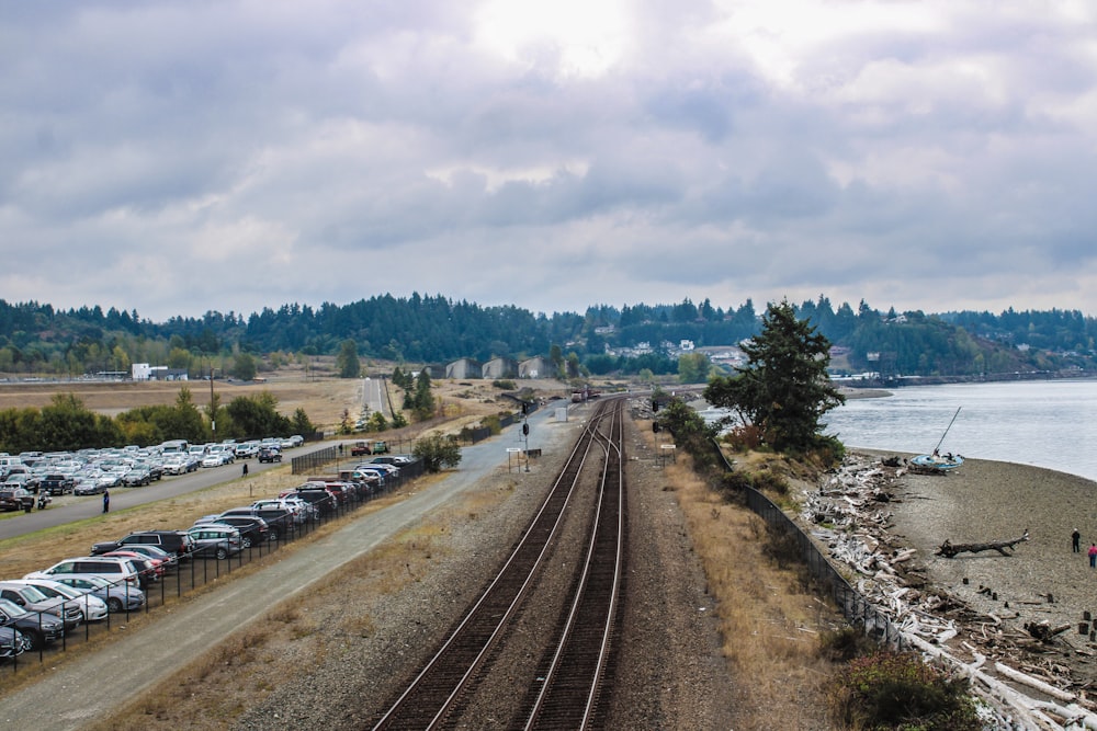 a long train track next to a body of water