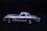 Close-up of a gleaming diecast car prize with metallic silver and red accents on a dark background.