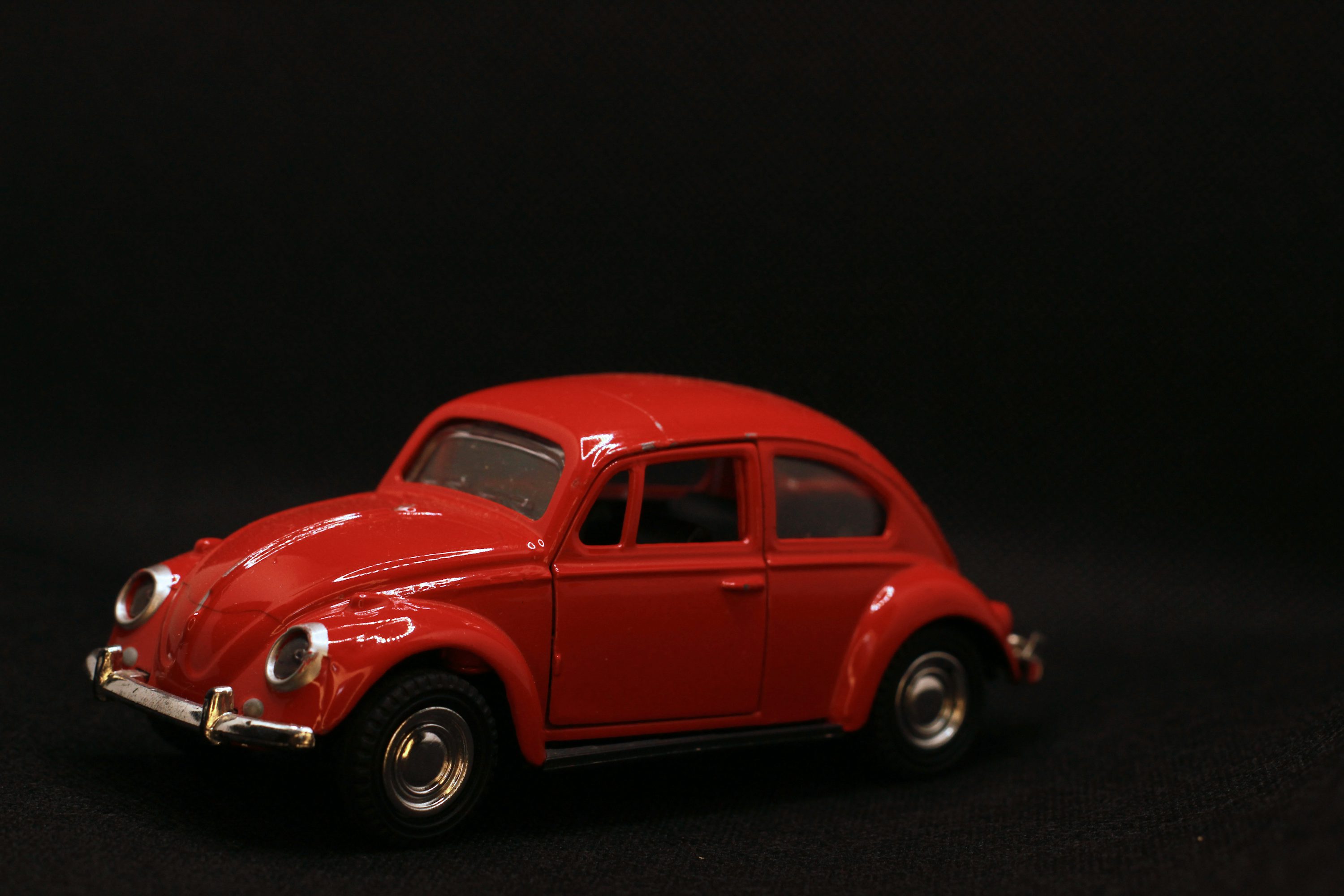 a red toy car on a black background